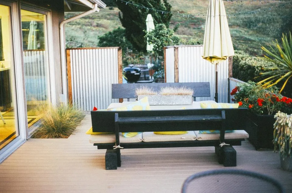 Built-in bench with cushions and an umbrella on a modern deck